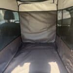 inside a dog kennel in a SUV
