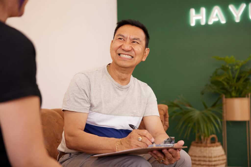Smiling patient at Haylo Dental clinic during consultation.