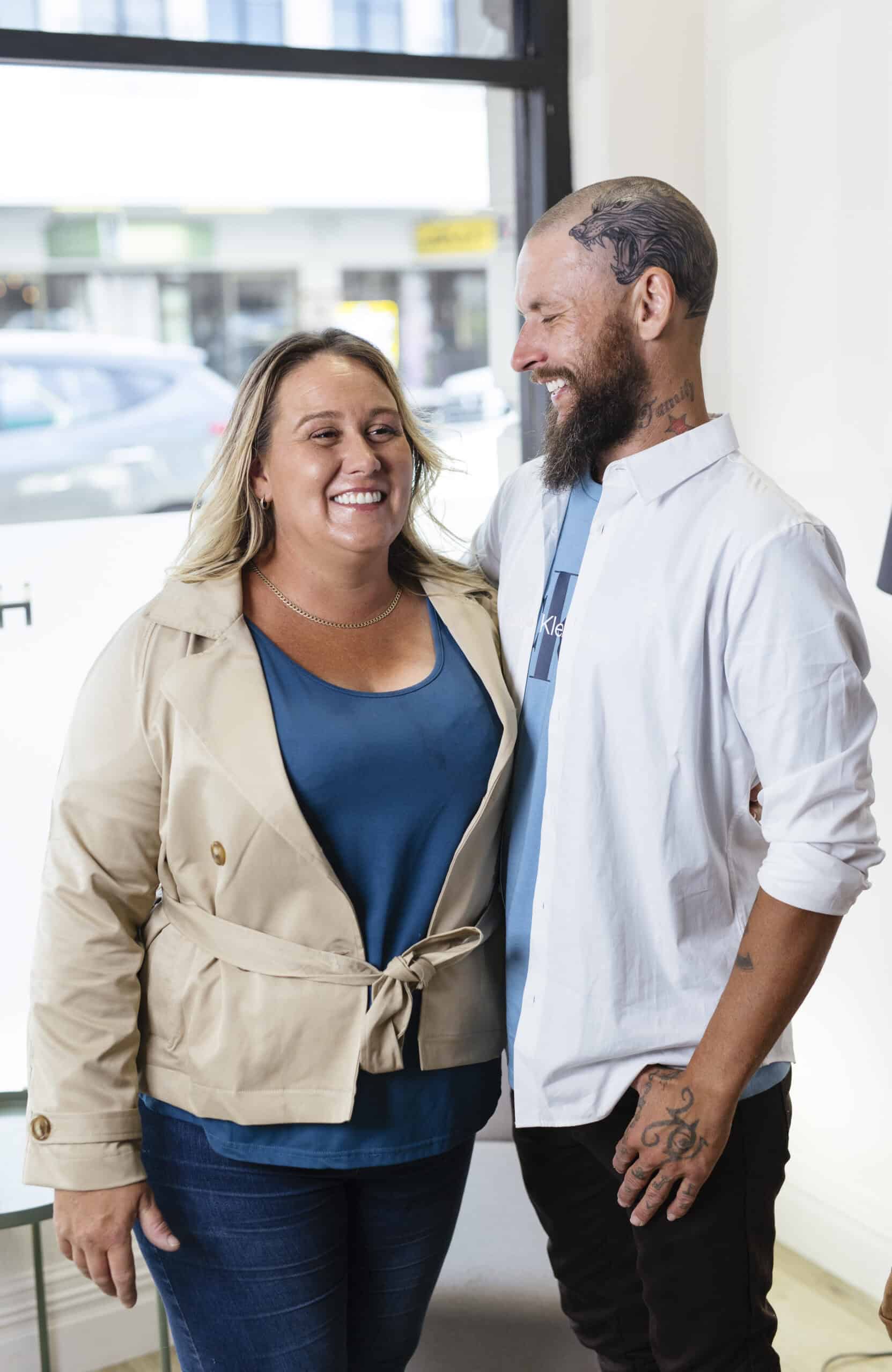 Smiling woman and male dentist sharing a friendly moment at Haylo Dental.