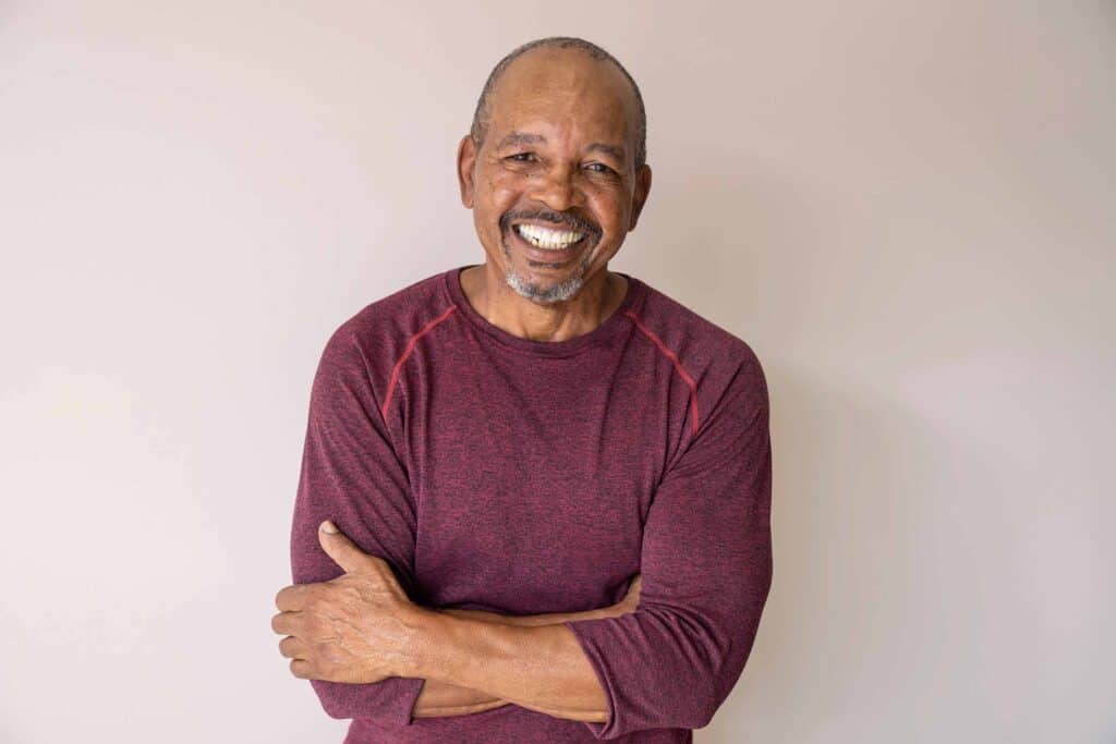 Smiling man with partial dentures showcasing dental restoration.