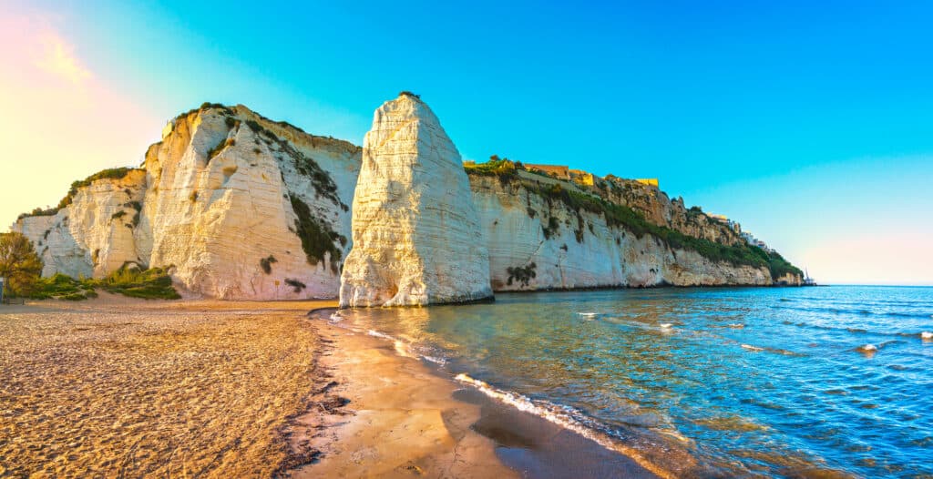 Beachside Vieste and Pizzomunno rock on the shoreline on the Gargano peninsula, Apulia, southern Italy