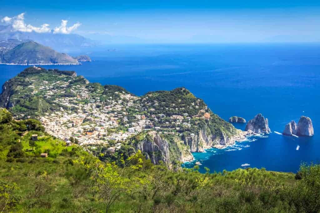 aerial view of Capri island town and the Faraglioni cliffs