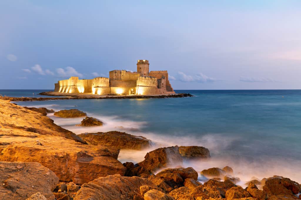 Isola di Capo Rizzuto in Calabria with The Aragon castle beautifully lit at dusk.