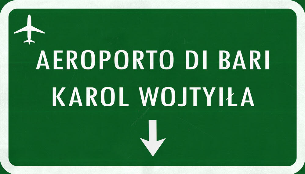 green sign with title Bari airport, one of the main airports in puglia italy.