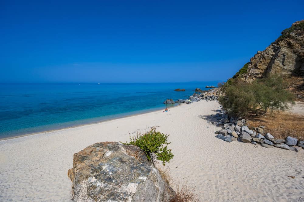 Deserted White sand beach with blue sea and sky