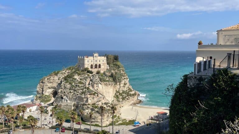 Scenic view of a castle on a cliff overlooking the sea in Calabria, Italy.
