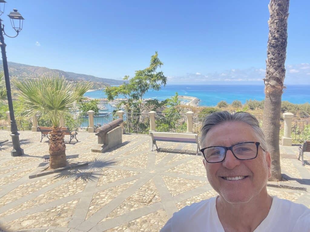 Man smiling with coastal background