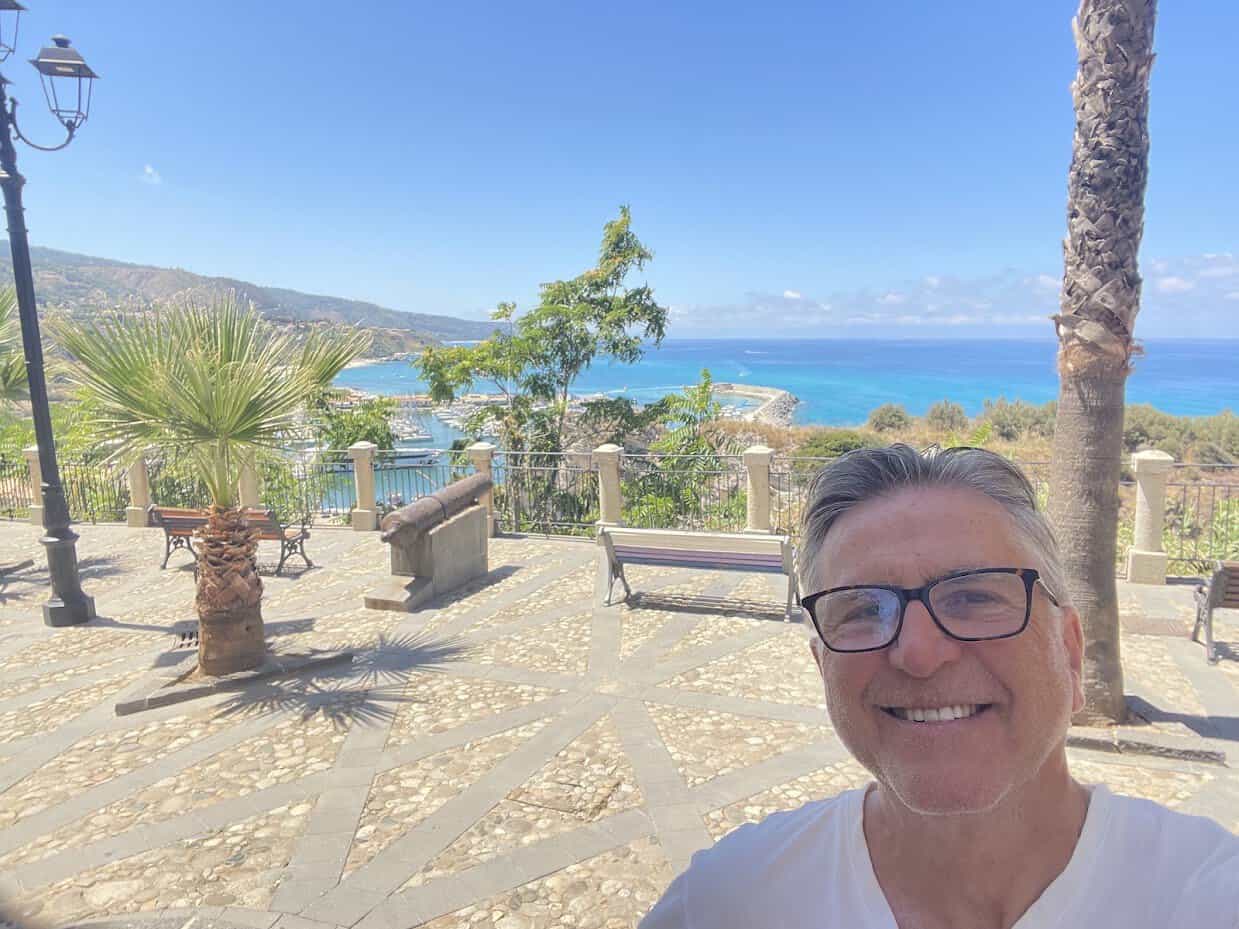 Man smiling with coastal background