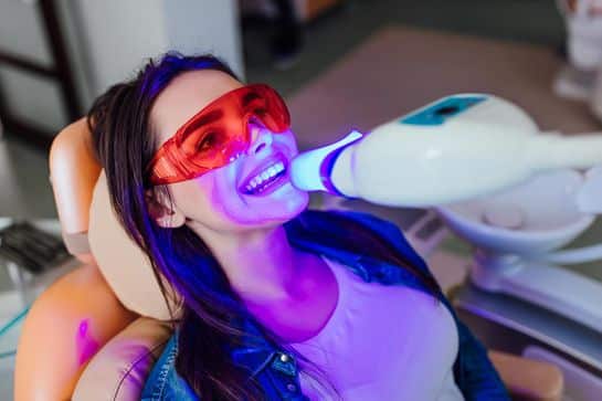 Dental patient receiving teeth whitening treatment at Heritage Dental Centre Edmonton.