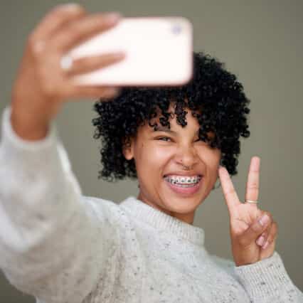 Family Dentist in South Edmonton | Heritage Dental 7 Girl with White teeth and Braces taking a selfie
