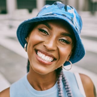 Family Dentist in South Edmonton | Heritage Dental 8 Girl wearing a bucket hat with white teeth smiling