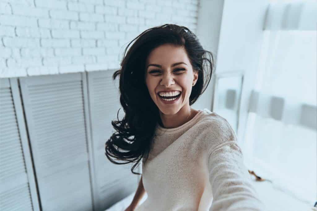 Laughing Person Taking Photo Of Themselves Open Mouth Smiling