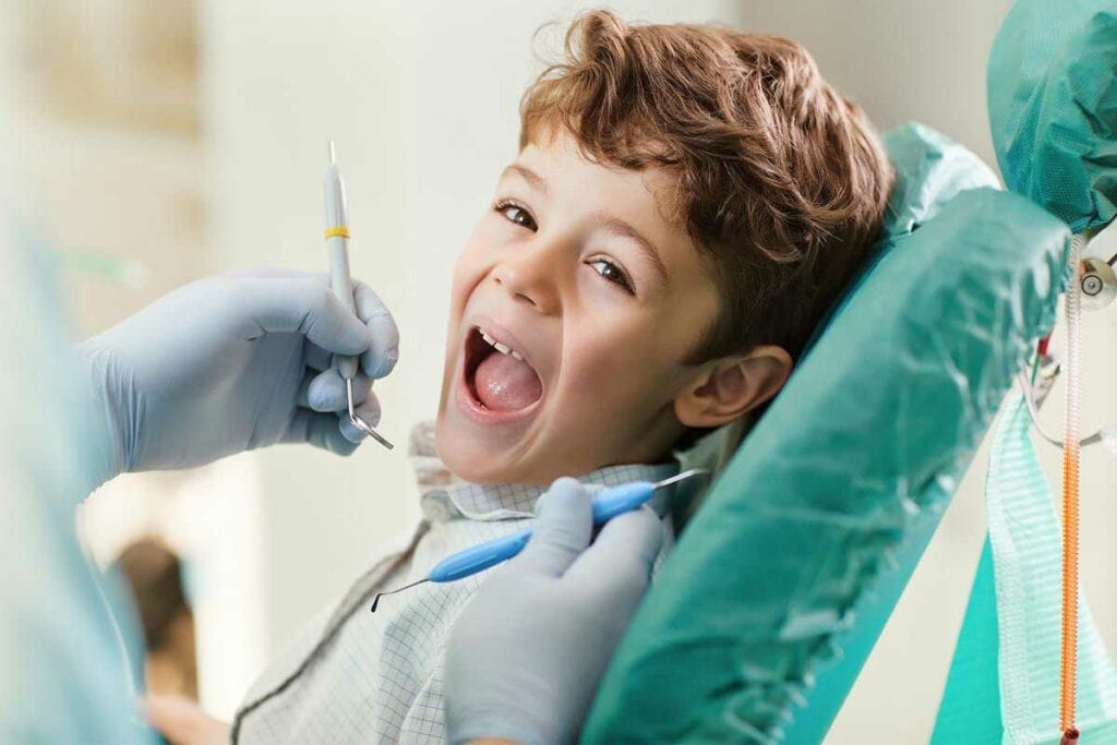 Young boy at dentist's office receiving dental examination and treatment in Edmonton.
