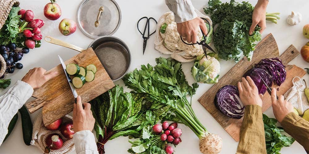 Fresh vegetables and herbs on cutting boards at Heritage Dental Centre for healthy smiles.