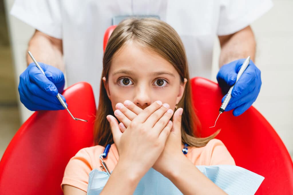 Young girl at the dentist clinic during a dental checkup or treatment.
