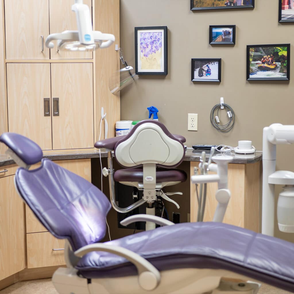 Bright dental exam room at Heritage Dental Centre with dentist chair and dental equipment in Edmonton.