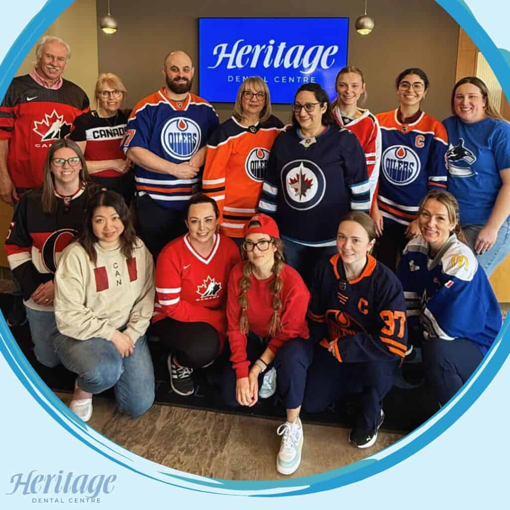 Let’s Go Oilers! Cheer Loud, Smile Proud, and Keep Your Teeth in the Game 1 Edmonton dental assistants smiling at Heritage Dental