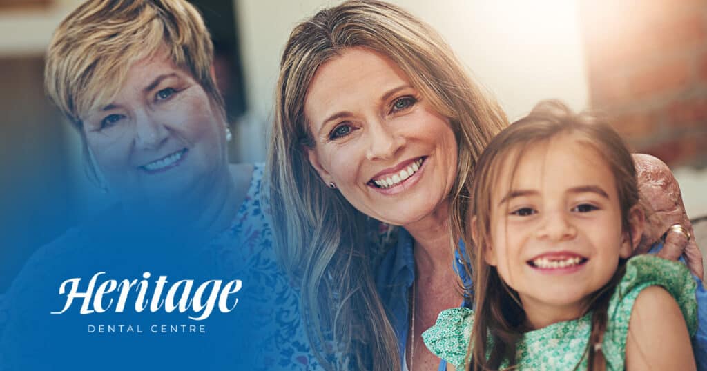 Smiling woman and girl at Heritage Dental Centre in Edmonton, capturing a friendly dental care experience.