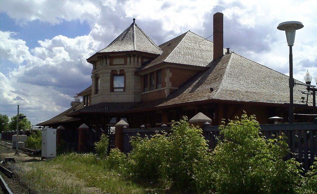 Heritage Dental Centre building with historic architecture located near train tracks in Edmonton, Alberta, emphasizing dental care in a historic setting.