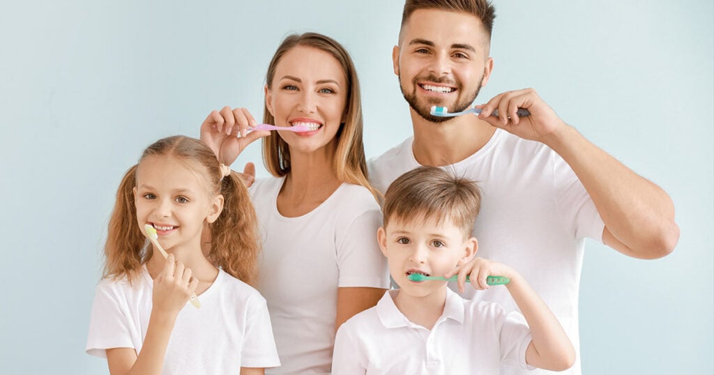 Brushing teeth family at dentist office, healthy smile, dental care, family dentistry, Heritage Dental Edmonton.