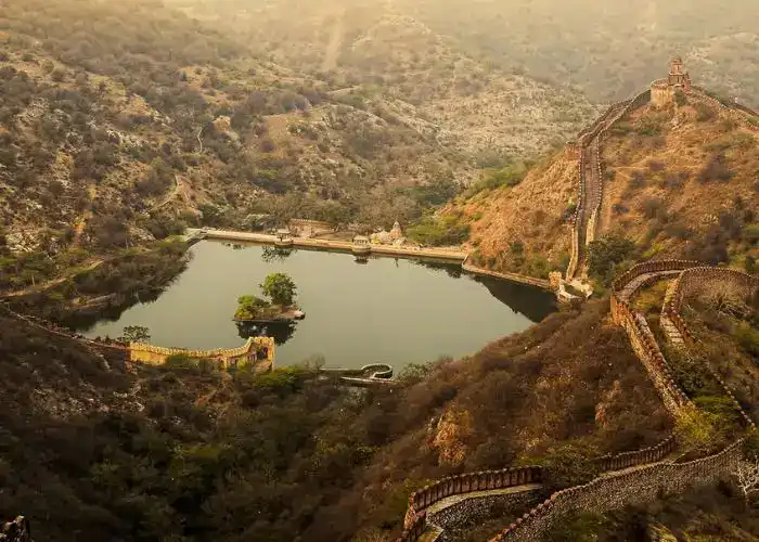 Jaigarh Fort overlooking a serene lake in the mountains.