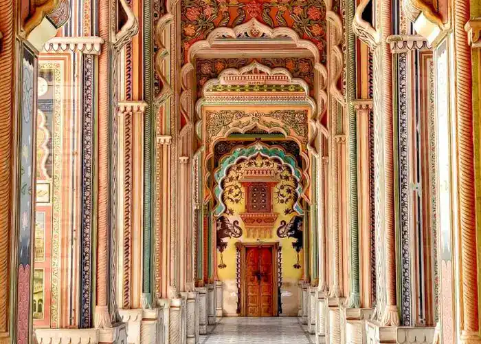 Intricate palace entrance with vibrant colors and detailed carvings, showcasing Rajasthan's rich arc.