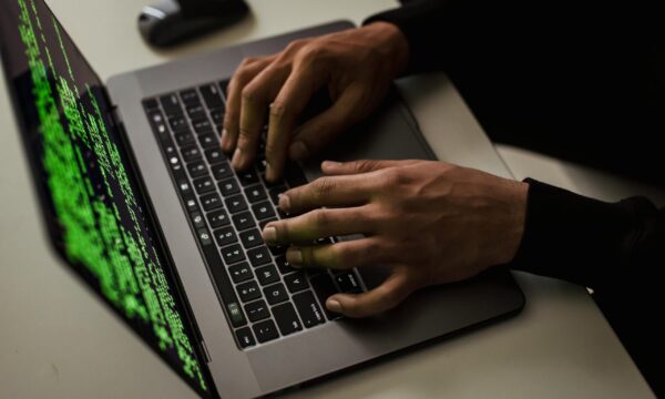crop-cyber-spy-hacking-system-while-typing-on-laptop