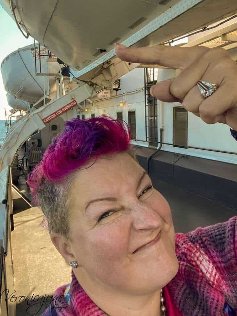 The author points at a lifeboat with a scrunched up face.