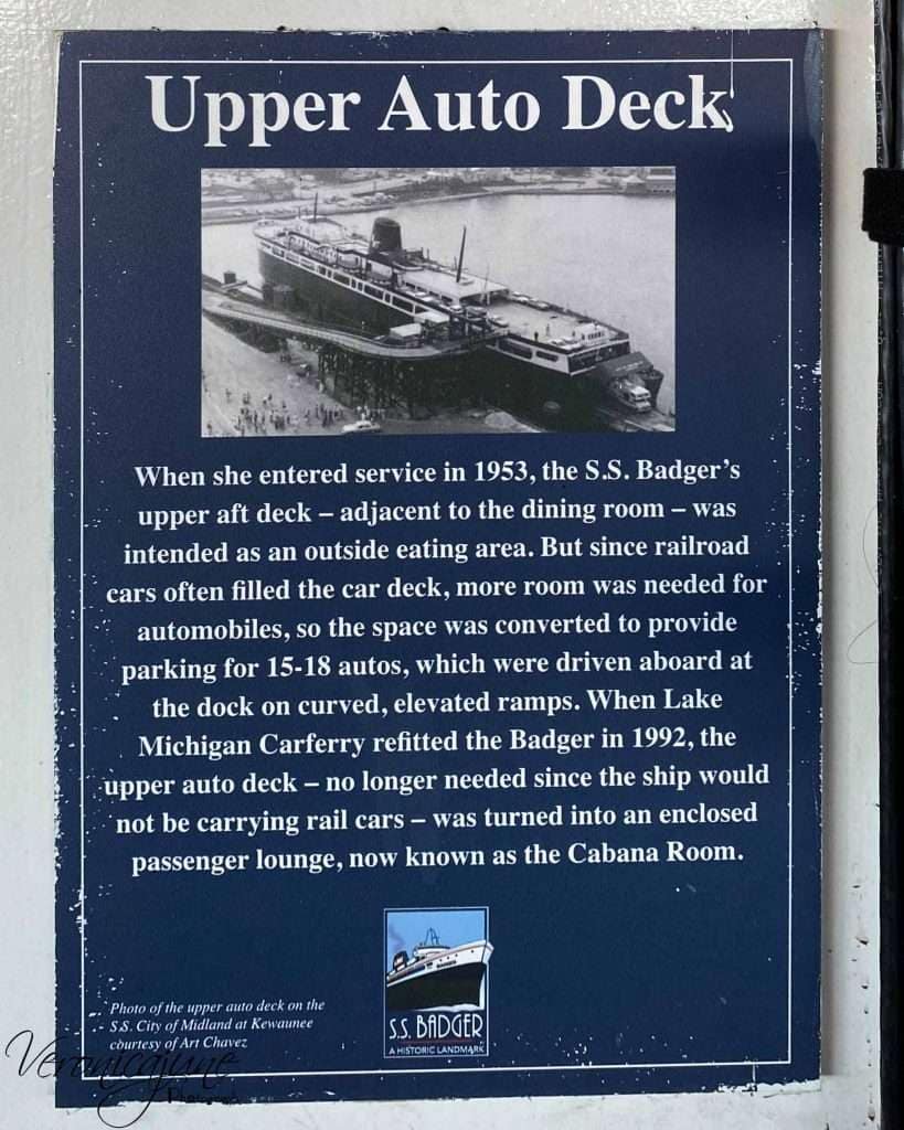 A navy blue plaque explaining the history of the Cabana Room on the SS Badger