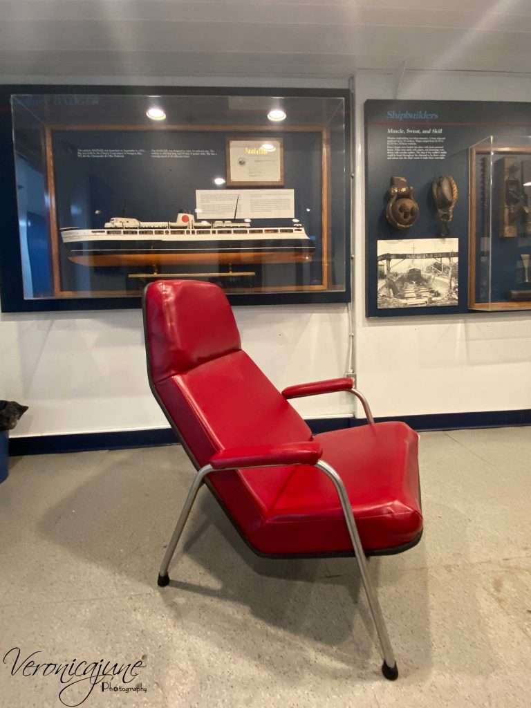 A very comfy red chair is pictured in the Badger's onboard Maritime Museum Room
