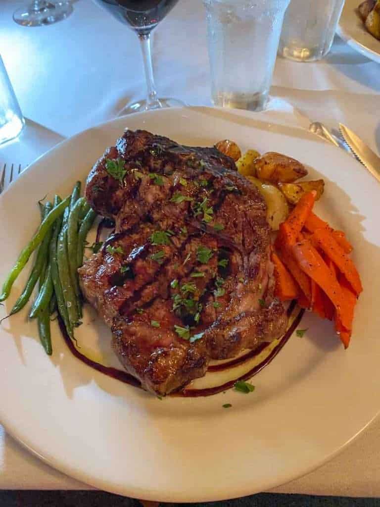 Ribeye steak with roasted vegetables and potatoes at Lino Ristorante Italiano, one of the Restaurants in Sheboygan WI