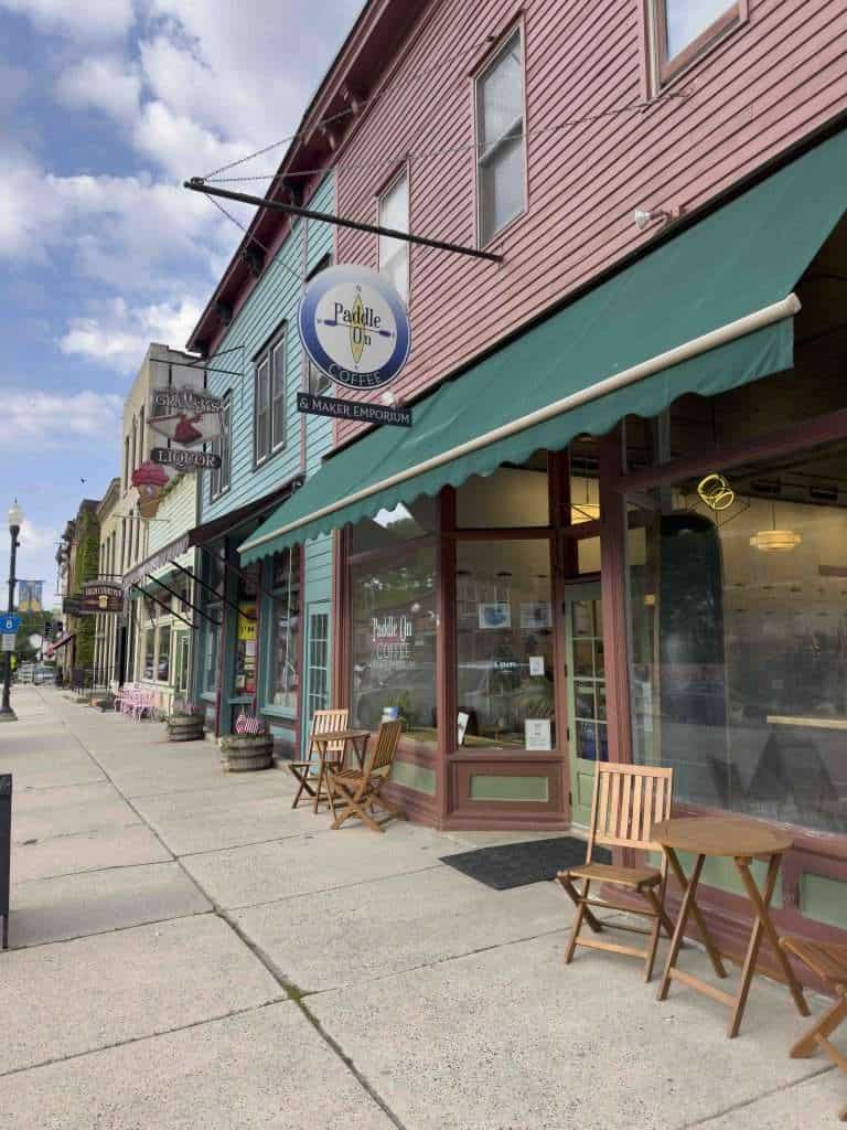 Colorful downtown coffee shop with outdoor seating and vibrant facades, Paddle On Coffee is one of the coziest places to eat in Lanesboro MN, perfect for relaxing with a cup of coffee.