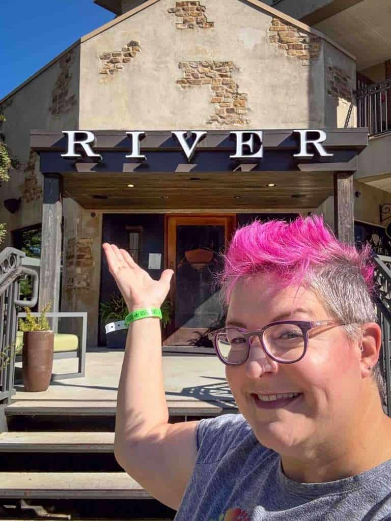 Hip Grandma points at the River entryway