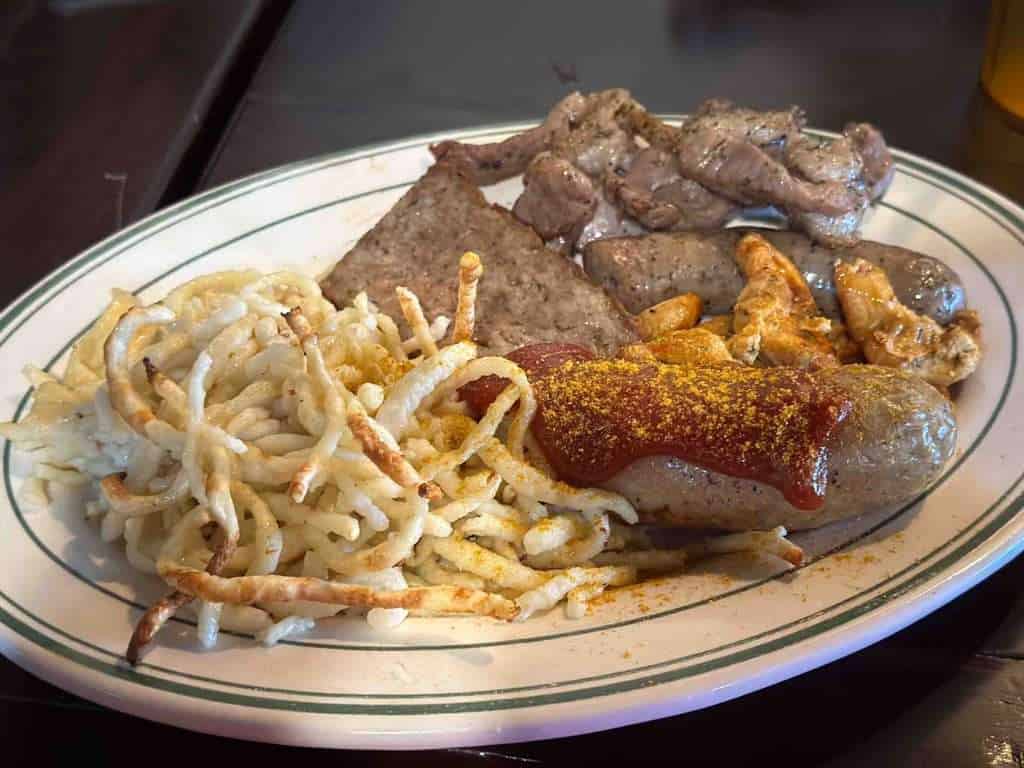 A plate with spaetzle and assorted meats from Rolf's