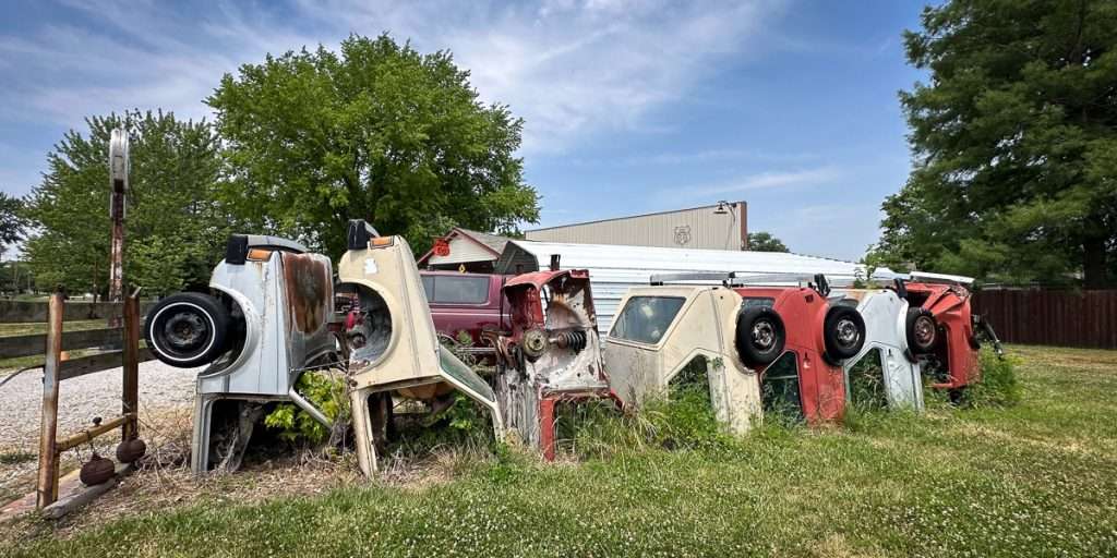 Row of upright vintage VW car fronts displayed like a quirky fence at Henry’s Rabbit Ranch in Staunton, Illinois.