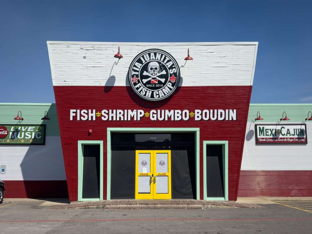 Tia Juanita’s Fish Camp restaurant exterior in Texas with Cajun and Mexican signage