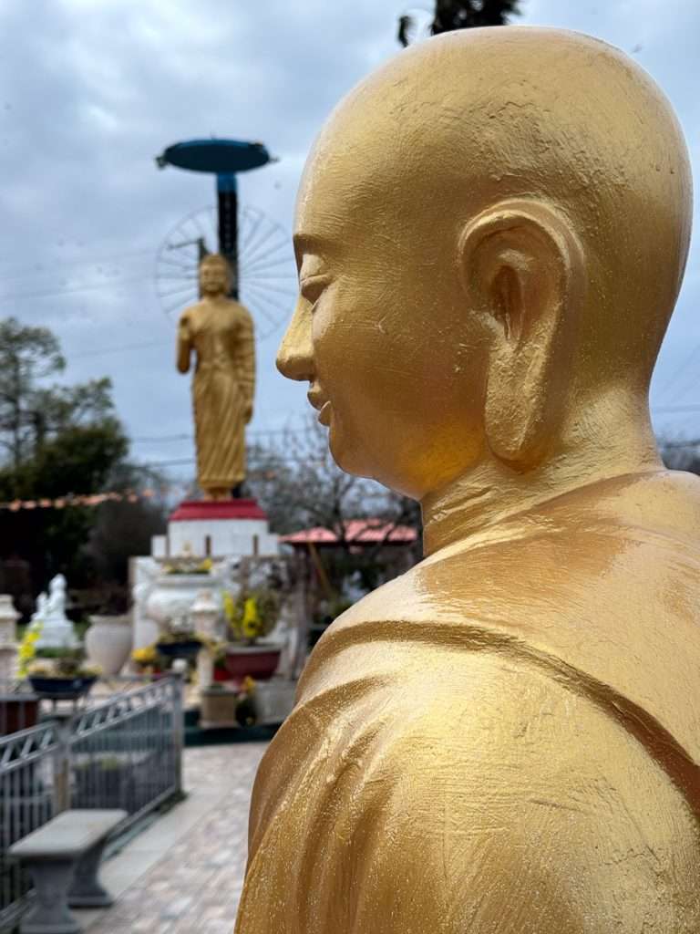 Buddha statue at Buu Mon Buddhist Temple in Port Arthur TX showcasing peaceful gardens and cultural diversity