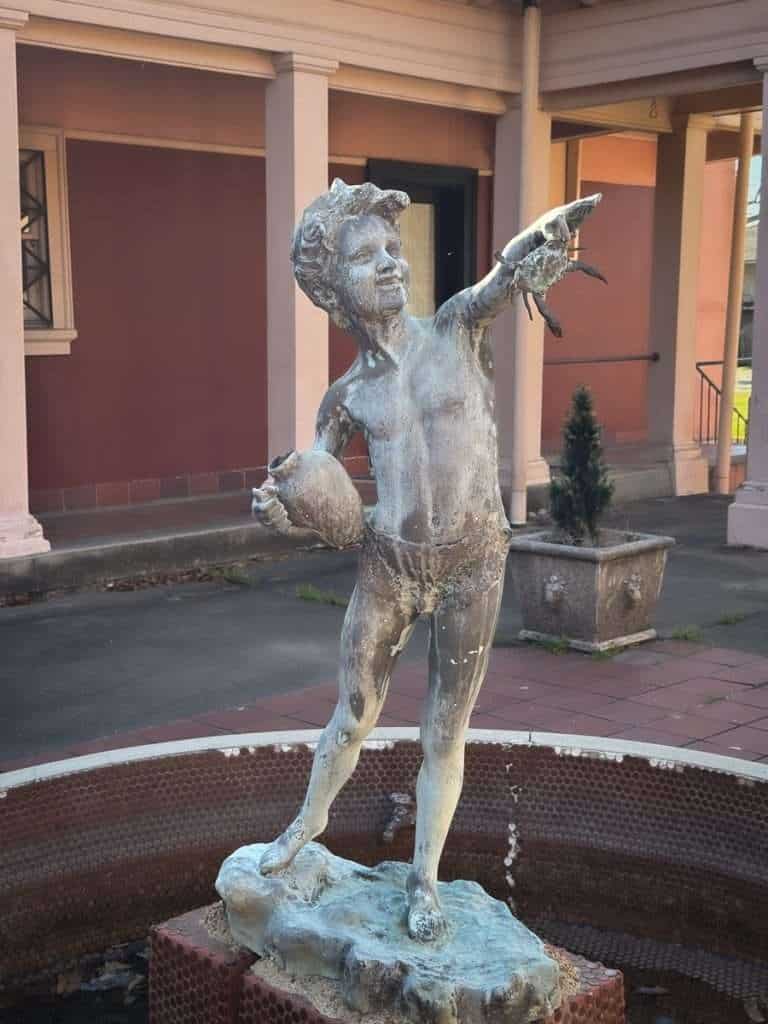 Fountain statue of boy holding crab at Pompeiian Villa in Port Arthur Texas