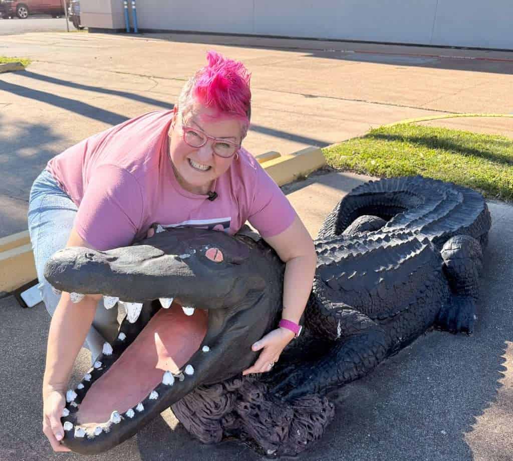 Hip Grandma posing with alligator statue at Museum of the Gulf Coast Port Arthur TX