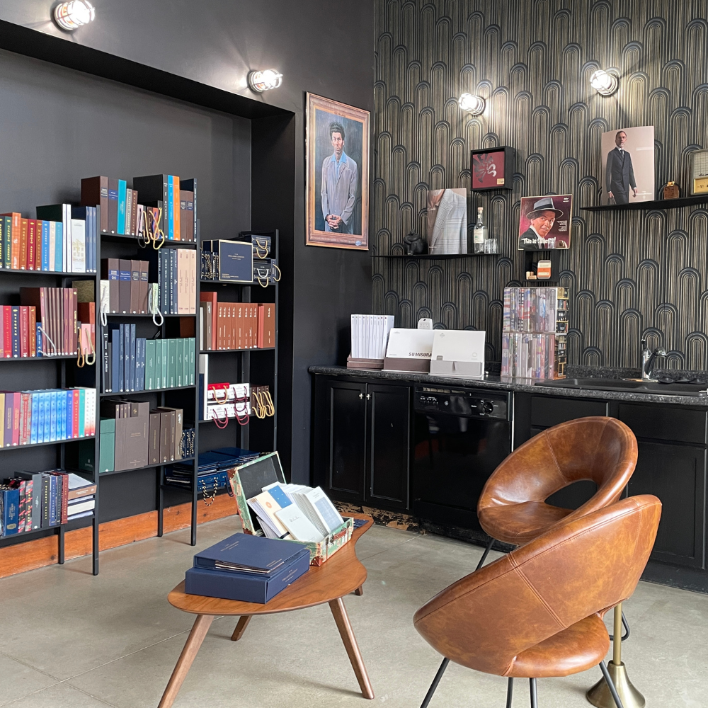 Modern office space with bookshelves and artwork, stylish furniture, and a cozy atmosphere.