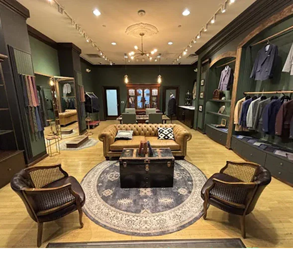 Elegant clothing store interior with vintage furniture and clothing displays.