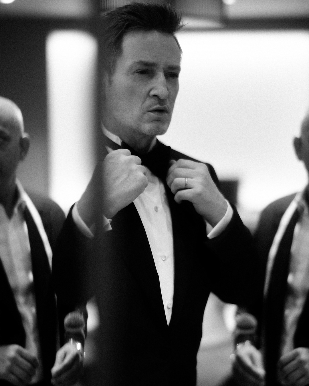 Man in a custom tuxedo preparing for a formal Boston wedding event