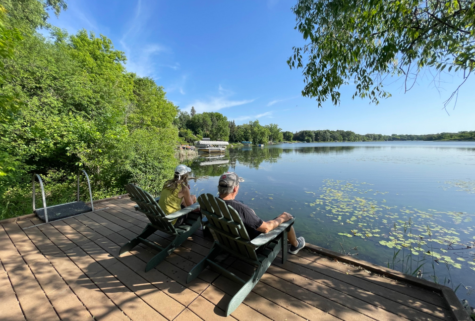 two people sitting by lake
