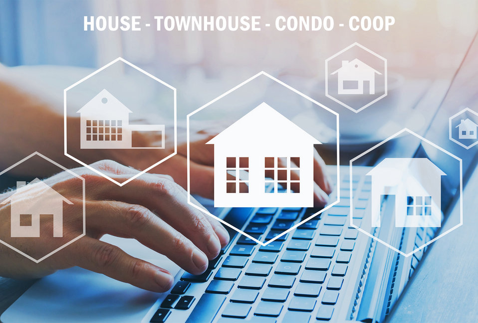 home styles house townhouse condo icons on image of hands on keyboard