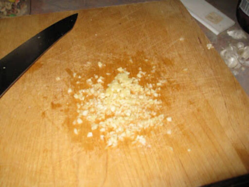 Image shows chopped garlic.