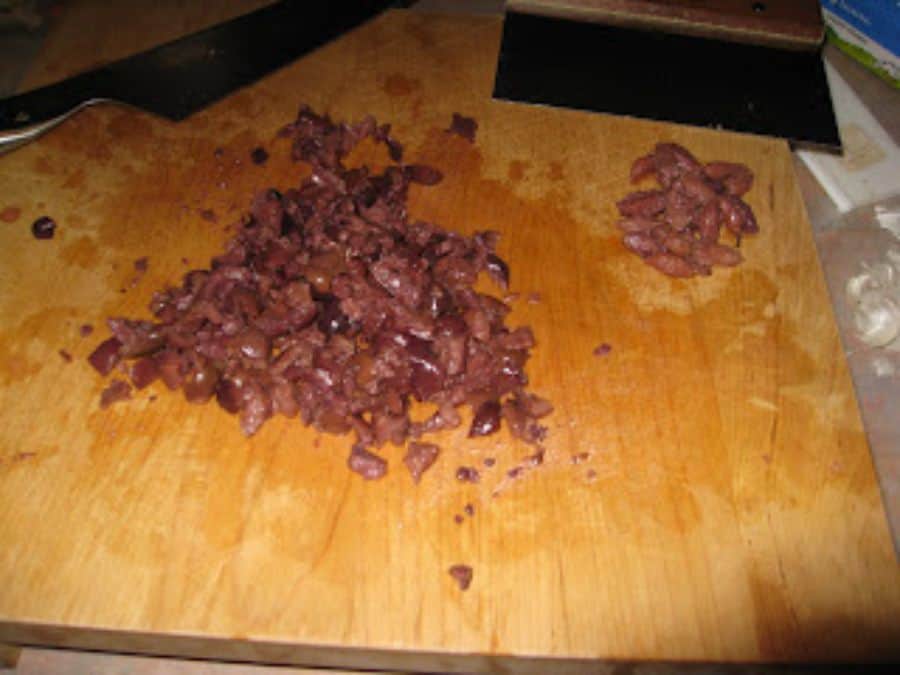 Image shows chopped kalamata olives.