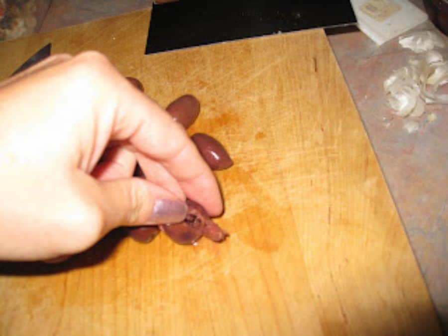 Image shows crushed kalamata olive.