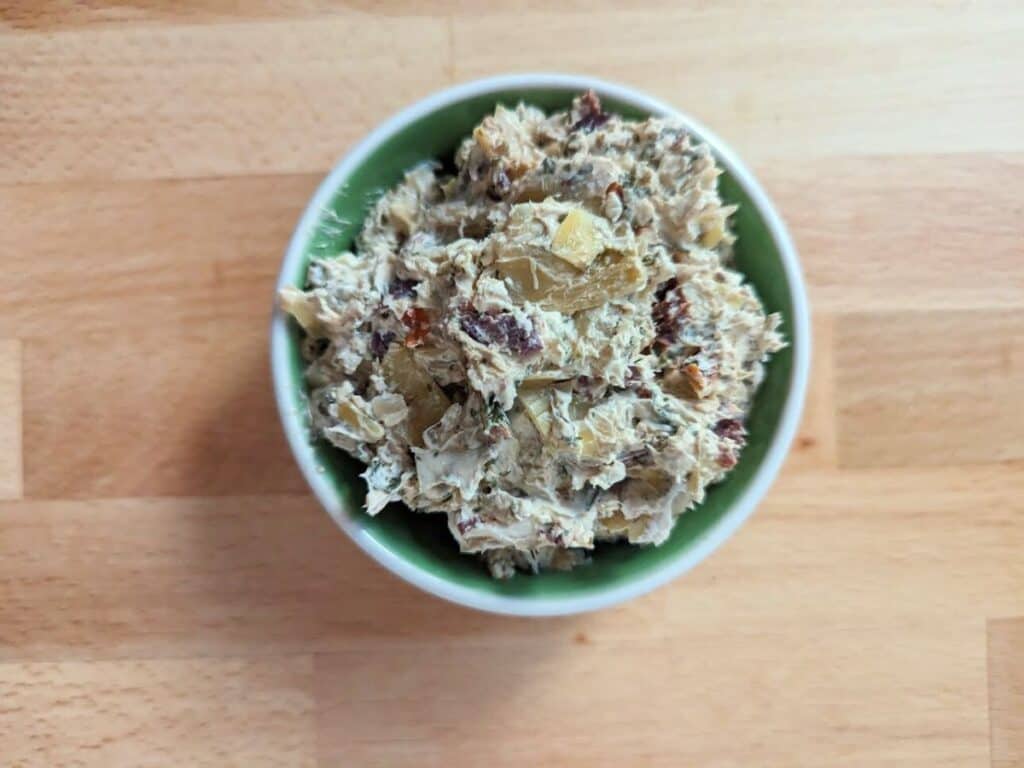 Image shows Tuscan artichoke and sundried tomato dip.