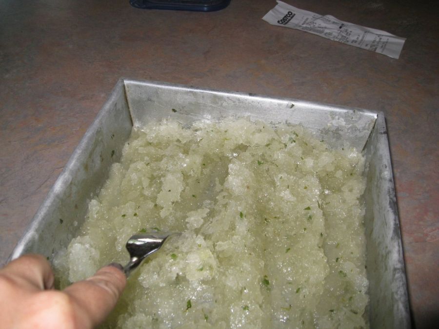 Image shows frozen mojito granita scraped using a fork.