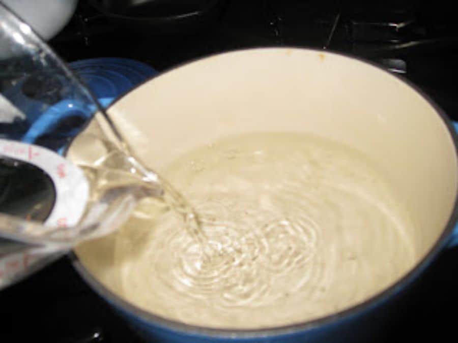 Image shows water poured into a nonreactive saucepan.